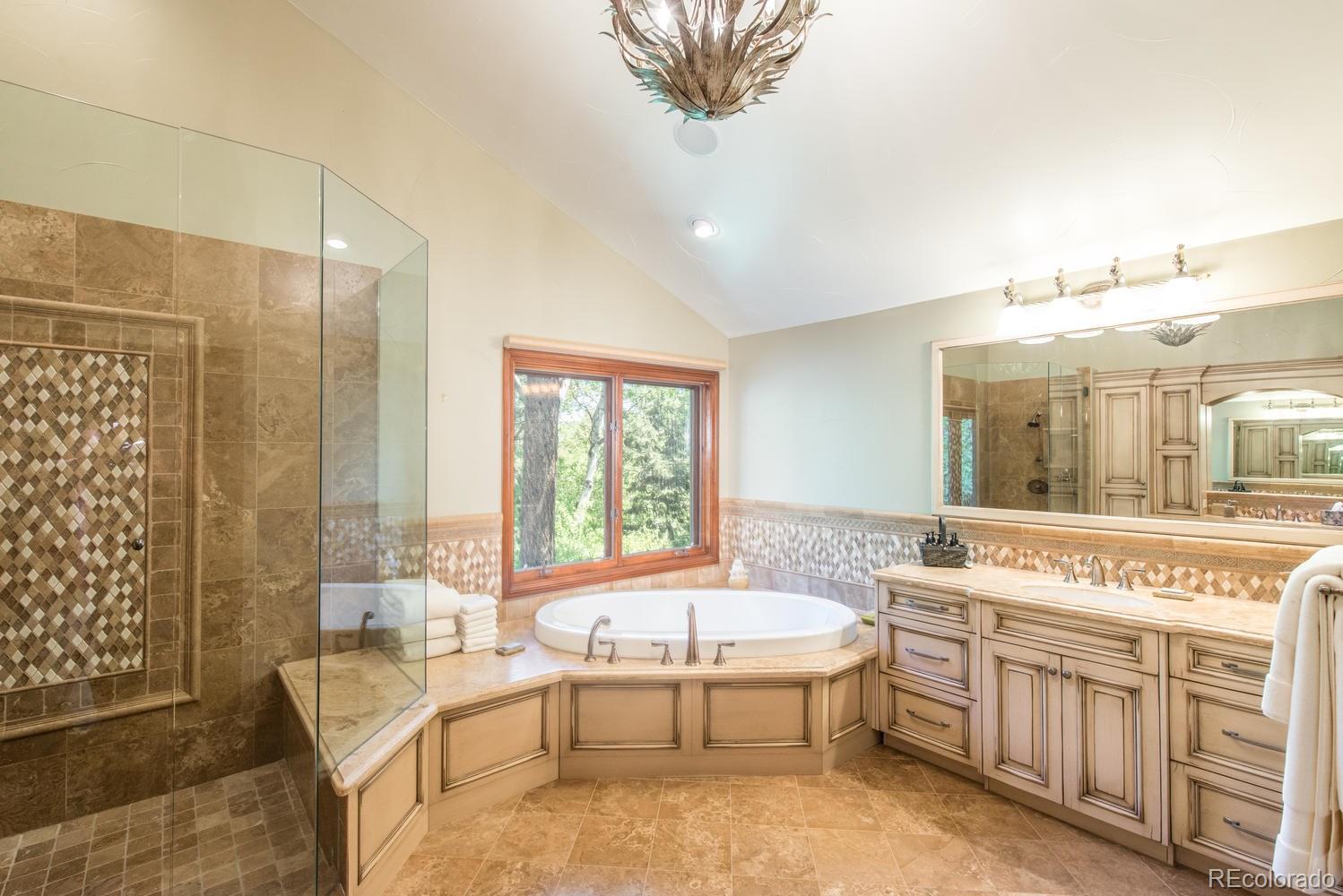 45 West Ranch Trail Morrison, CO 80465 - Photo 18 of 35 a spacious bathroom with a tub a sink and mirror