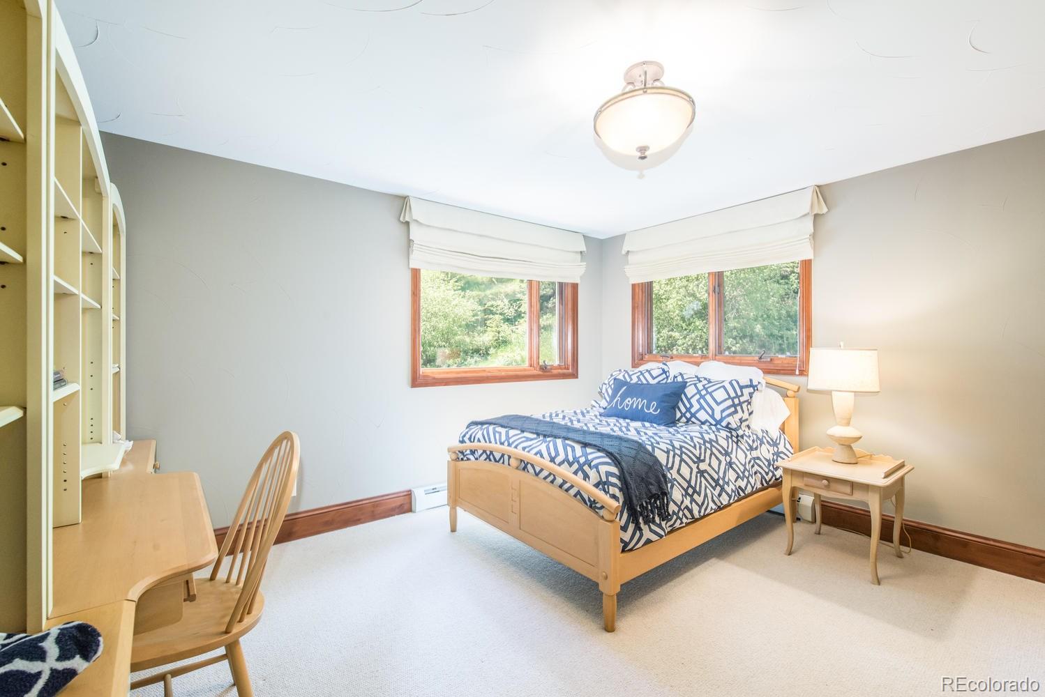 45 West Ranch Trail Morrison, CO 80465 - Photo 22 of 35 a bed sitting in a bedroom next to a window