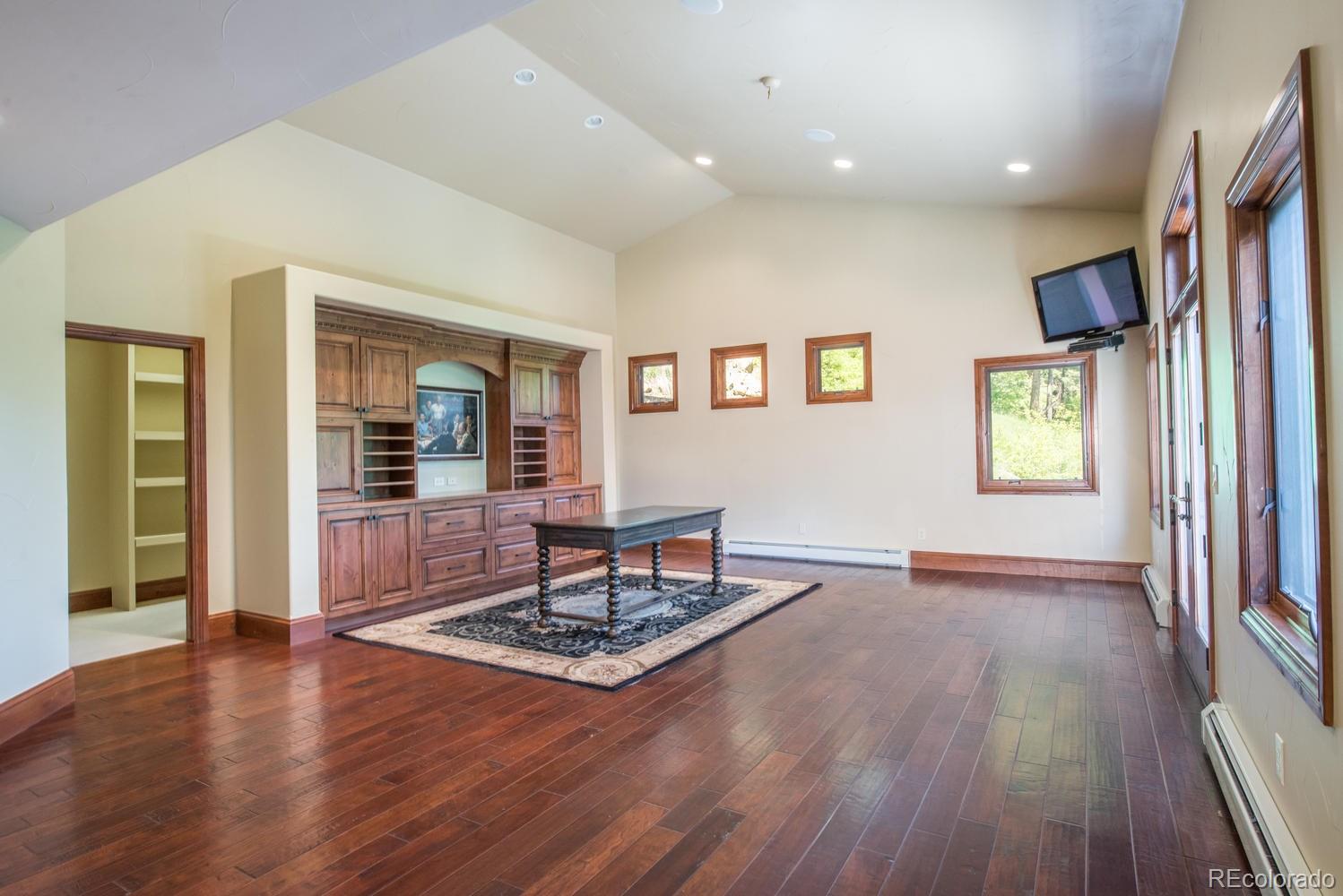 45 West Ranch Trail Morrison, CO 80465 - Photo 27 of 35 a living room with couch dining table and wooden floor