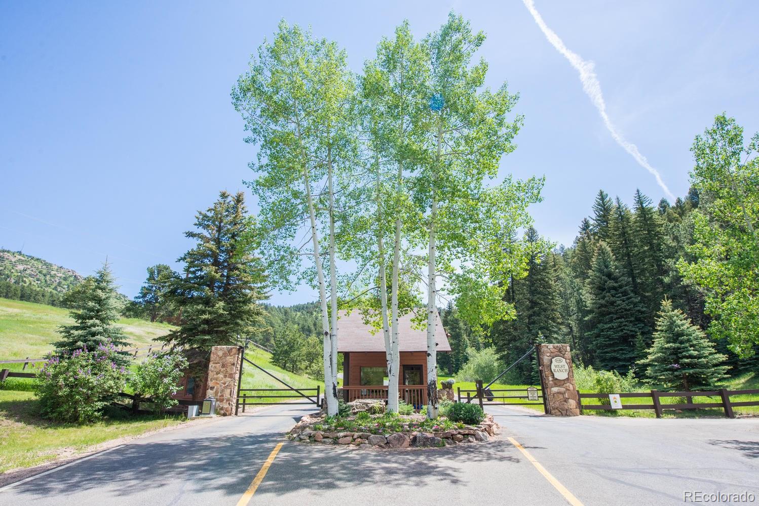 45 West Ranch Trail Morrison, CO 80465 - Photo 33 of 35 a front view of a house with garden
