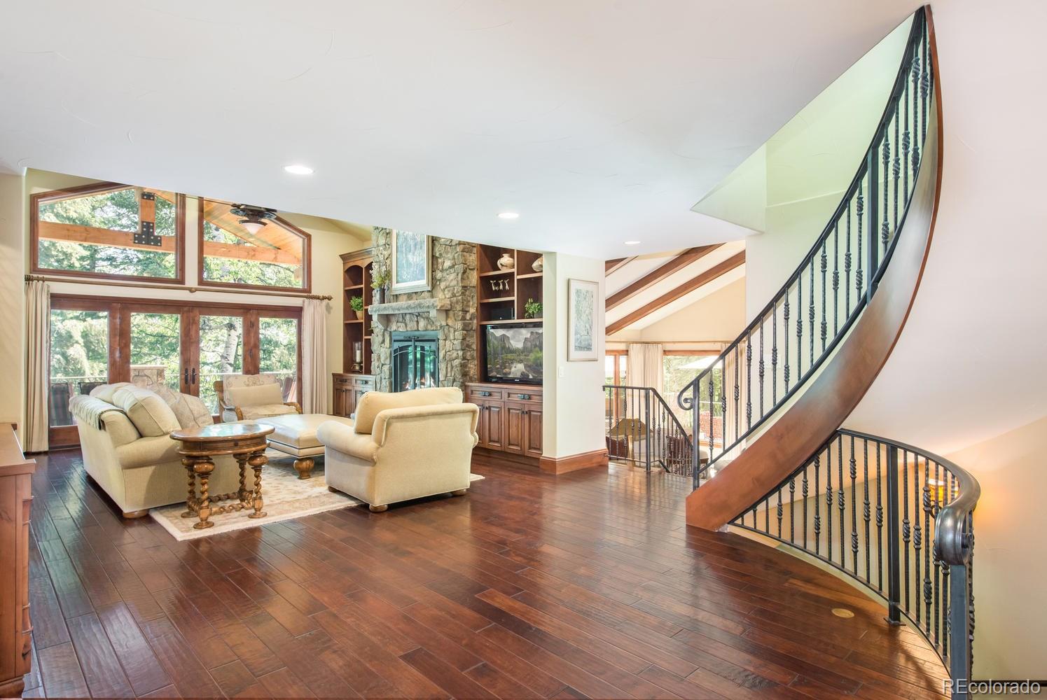 45 West Ranch Trail Morrison, CO 80465 - Photo 7 of 35 a living room with furniture wooden floor and windows