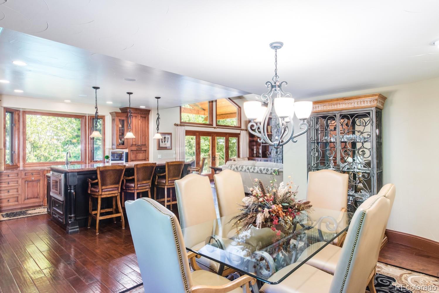 45 West Ranch Trail Morrison, CO 80465 - Photo 9 of 35 a view of a dining room with furniture window and wooden floor