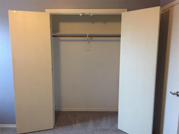 a bathroom with a sink a toilet a mirror and shower curtain