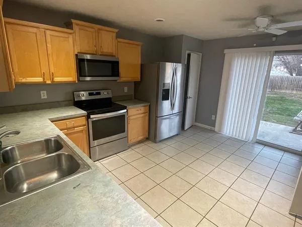 a kitchen with stainless steel appliances a stove a refrigerator and a sink