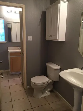 a white toilet sitting next to a bathroom sink