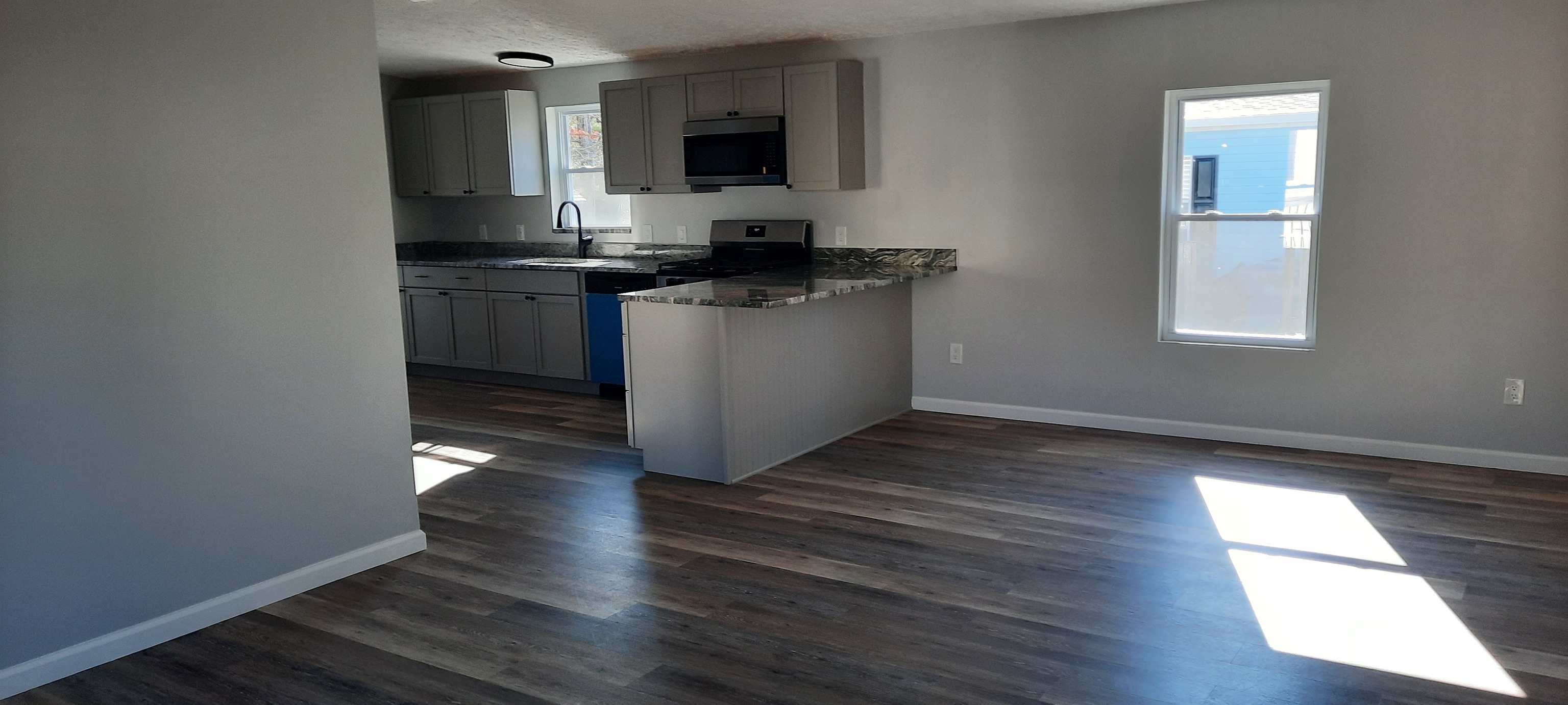 a kitchen with a sink and a stove top oven