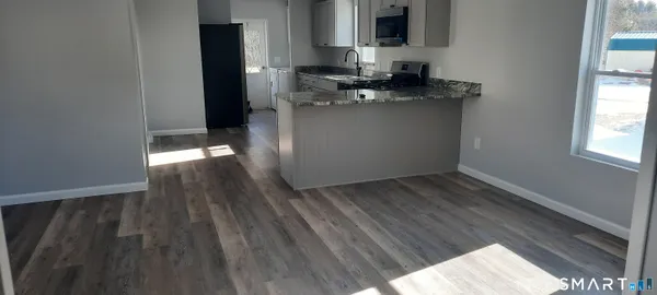 a kitchen with a wooden floor and a sink