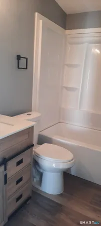 a bathroom with a toilet a sink and a window