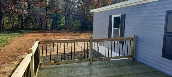 a front view of house with yard patio and wooden fence