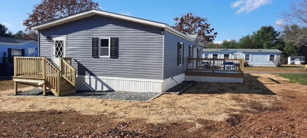 a view of wooden house with a yard