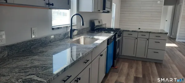 a kitchen with sink and cabinets