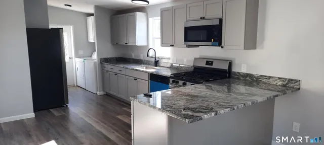 a view of bedroom with wooden floor