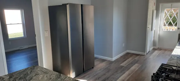 a view of bedroom with wooden floor