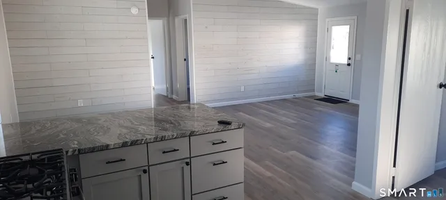 a small space with wooden floor and a window