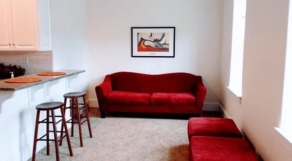 a large bed sitting in a bedroom next to a lamp