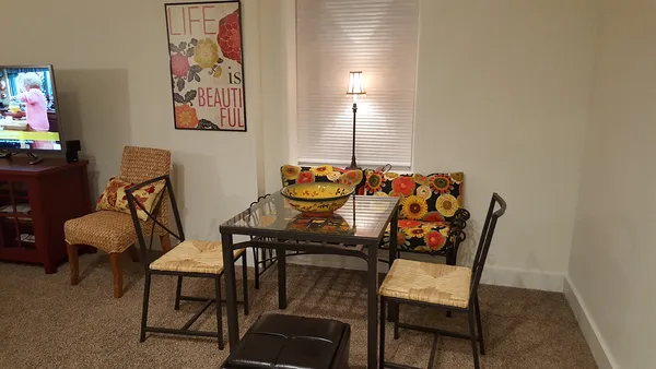 a living room with furniture rug and lamp