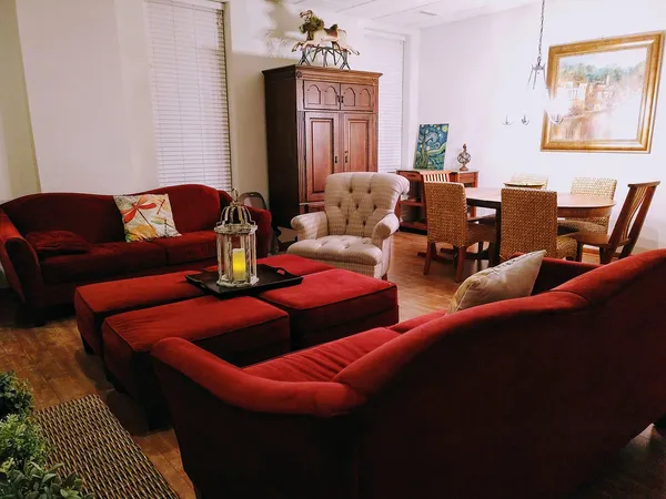 a living room with furniture a flat screen tv and a fireplace