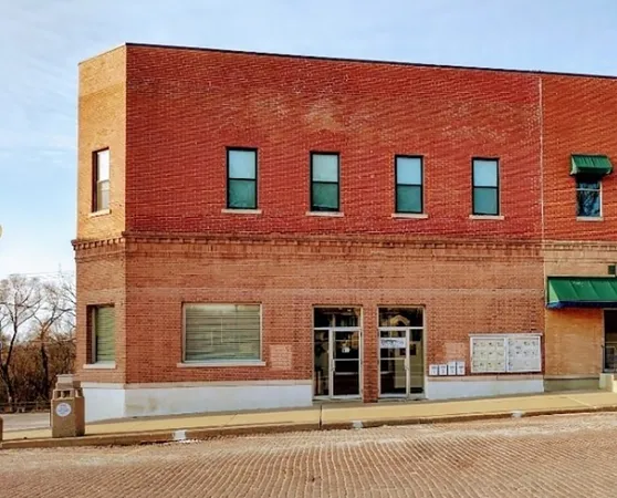 a front view of a house with a road