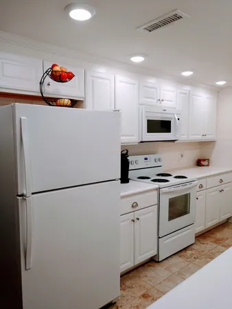 a kitchen with cabinets appliances and a sink