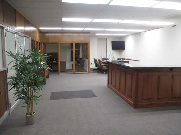 a lobby with furniture and potted plants