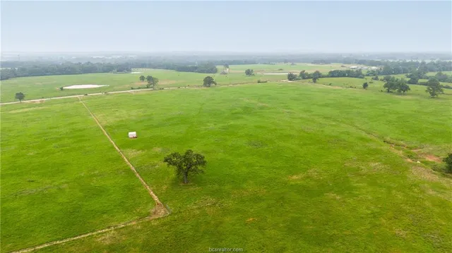 a view of a field with an outdoor space