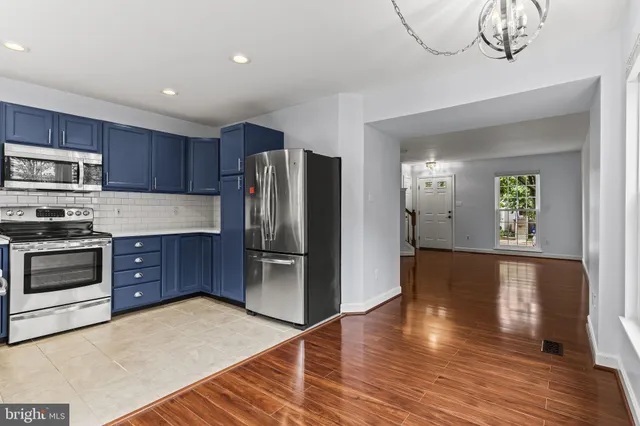 a kitchen with stainless steel appliances granite countertop a refrigerator microwave and stove