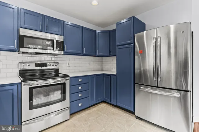 a kitchen with granite countertop stainless steel appliances and wooden cabinets