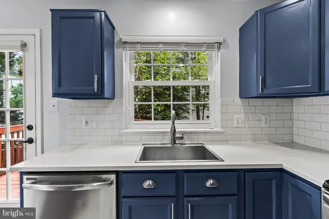 a kitchen with a sink cabinets and window