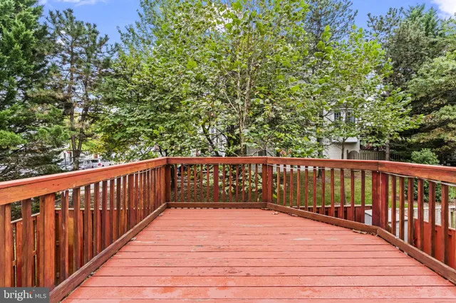 a balcony with wooden floor and trees