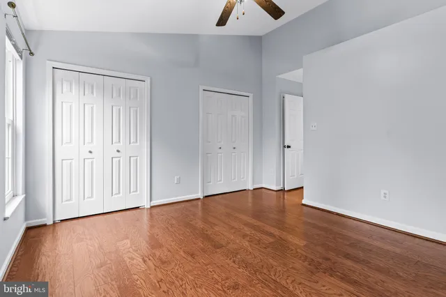 a view of an empty room with wooden floor