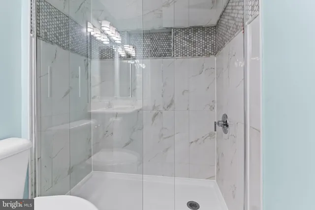 a bathroom with a shower curtain and a sink