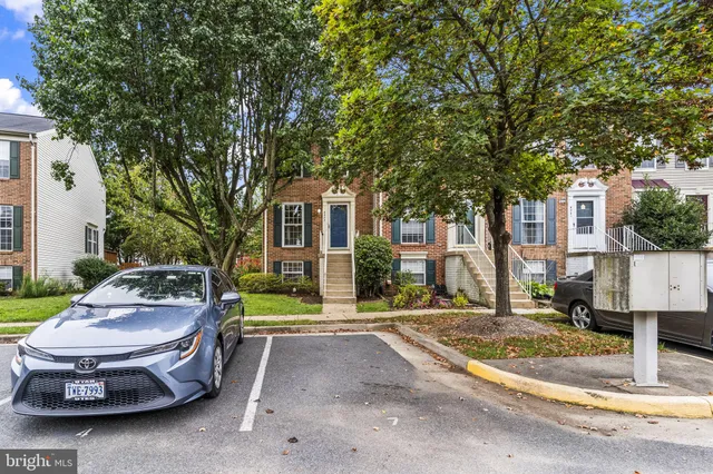 a white house that has a tree in front of it