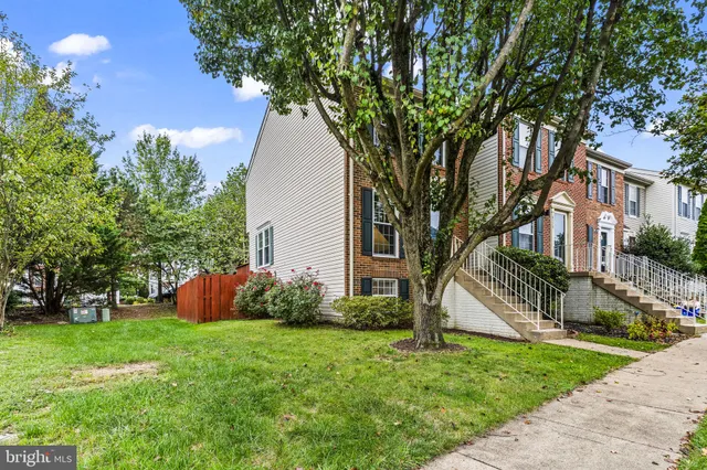 a view of a house with a yard and tree s