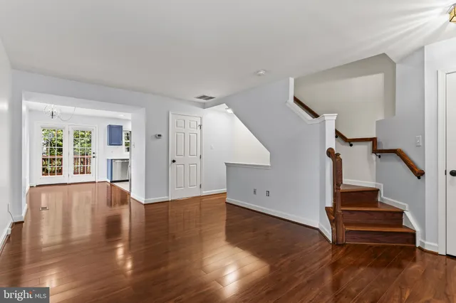 a view of an entryway with wooden floors and stairs