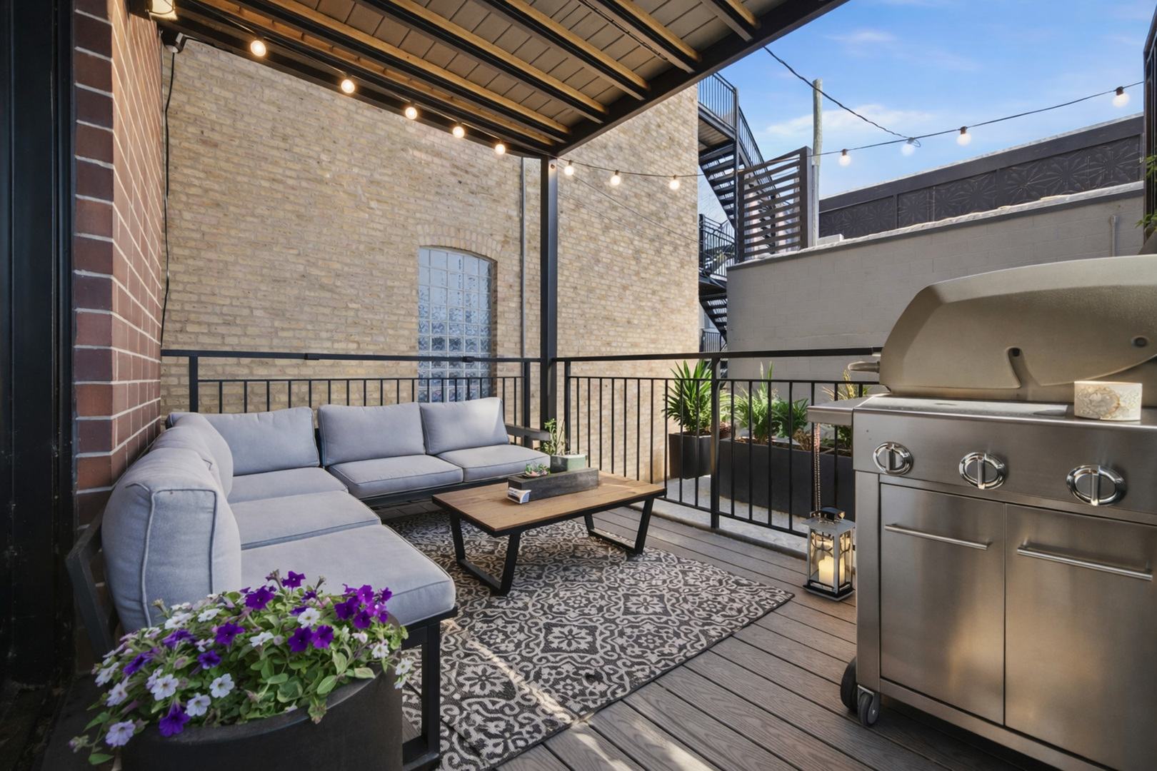 855 North Wolcott Avenue, Unit 1 Chicago, IL 60622 - Photo 12 of 34 a roof deck with couch and flowers