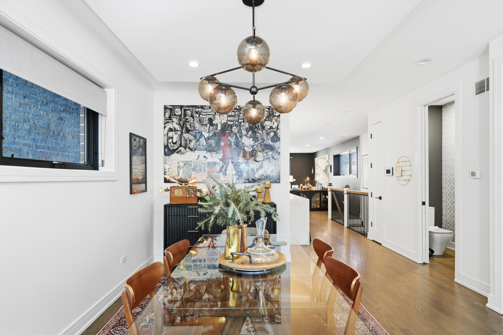 855 North Wolcott Avenue, Unit 1 Chicago, IL 60622 - Photo 15 of 34 a dining room with wooden floor a chandelier a wooden table and chairs