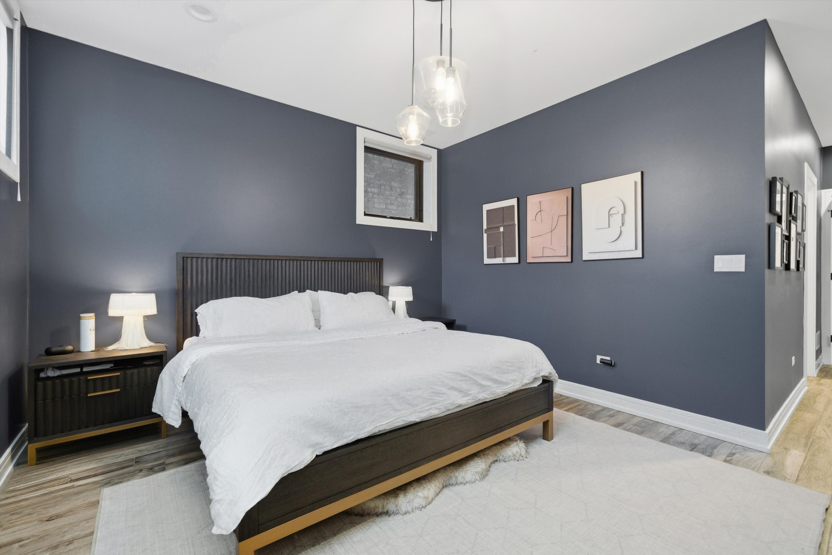 855 North Wolcott Avenue, Unit 1 Chicago, IL 60622 - Photo 22 of 34 a bedroom with a bed and a night stand