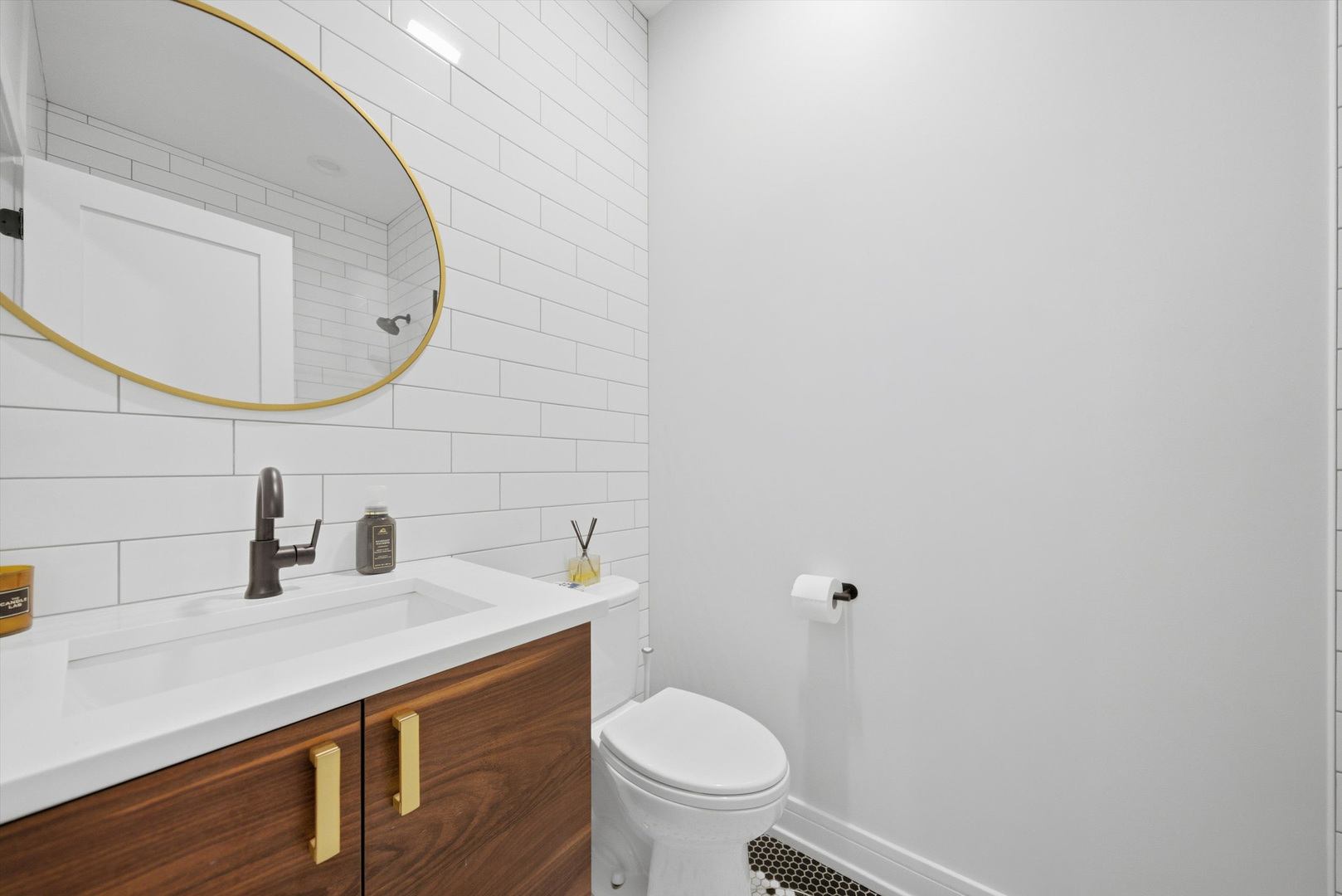 855 North Wolcott Avenue, Unit 1 Chicago, IL 60622 - Photo 29 of 34 a bathroom with a granite countertop toilet sink and mirror