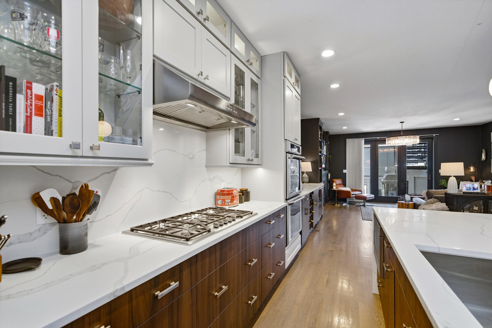 855 North Wolcott Avenue, Unit 1 Chicago, IL 60622 - Photo 5 of 34 a kitchen with stainless steel appliances a sink a stove and a wooden floor