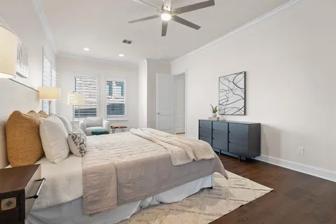 a bedroom with a large bed and a chandelier