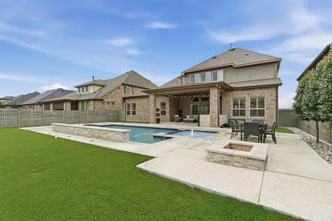 a view of house with yard outdoor seating and barbeque oven