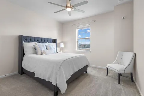 a spacious bedroom with a bed and a window