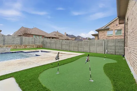 a view of a house with a backyard and a swimming pool