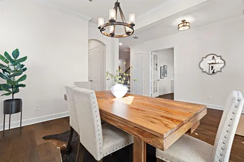 a dining room with a table and chairs