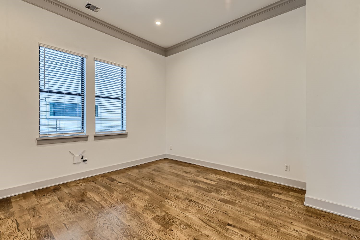 2208 Arabelle Street Houston, TX 77007 - Photo 7 of 26 a view of empty room with wooden floor and fan
