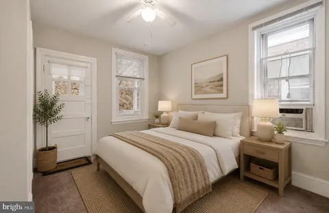 a bedroom with a bed and a potted plant