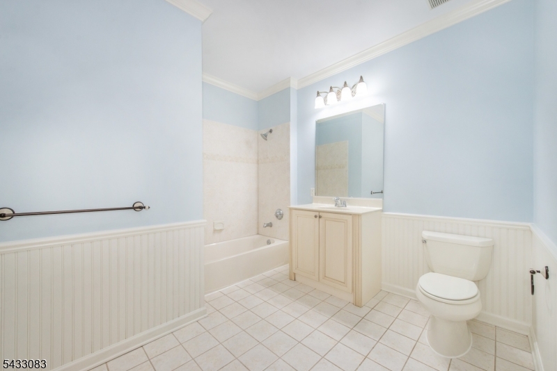 29 Ridgeview Lane, Unit 29 Mount Arlington, NJ 07856 - Photo 22 of 39 a bathroom with a toilet a sink a mirror and vanity
