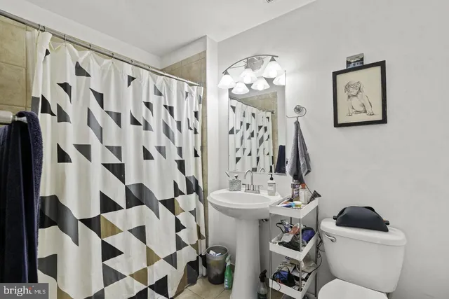 a bathroom with a sink and mirror with toilet