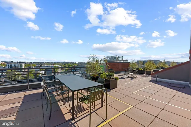 a view of a terrace with furniture and city view