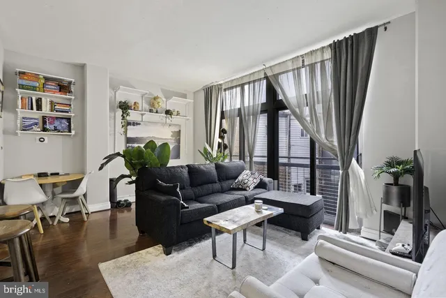 a living room with furniture and a floor to ceiling window